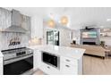 Modern kitchen with stainless appliances and an open view to the living room and access to outdoor living at 327 Francis Dr, Apollo Beach, FL 33572