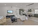 Open-concept living space with hardwood floors, neutral decor, and modern lighting at 3310 W 9Th Ave, Bradenton, FL 34205