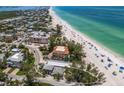 Coastal home near the beach with tropical trees, and nearby beach access at 3720 Gulf Dr, Holmes Beach, FL 34217