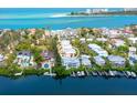 Stunning aerial view showcases the waterfront property with boat docks and ocean views at 3954 Hamilton Club Cir # 14, Sarasota, FL 34242
