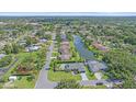 An aerial view shows many homes alongside a waterway, with abundant trees, grass, and landscaping at 4396 Pasadena Cir, Sarasota, FL 34233