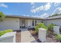 Charming front entrance with garden beds and greenery adding to the curb appeal of this home at 4396 Pasadena Cir, Sarasota, FL 34233