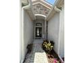 Close up of the front door with brick pavers, stacked stone and dark wood door with transom window at 4407 67Th E St, Bradenton, FL 34203