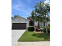 Well maintained single Gathering home with manicured lawn and a large shade tree in the front yard at 4407 67Th E St, Bradenton, FL 34203