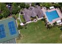 Aerial view of neighborhood amenities including a pool, tennis courts, playground, and clubhouse at 4716 98Th E Ter, Parrish, FL 34219
