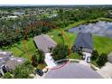 An aerial view of a single-Gathering home with a fenced yard and a pond nearby in a quiet neighborhood at 4716 98Th E Ter, Parrish, FL 34219