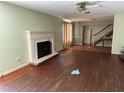 Living room with decorative fireplace, wood floors, and stairs in the background at 5124 17Th Street E Ct, Bradenton, FL 34203