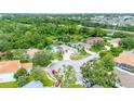 Overhead view of a lovely home with backyard pool and surrounding neighborhood with lush greenery and nearby pond at 5139 50Th W Ave, Bradenton, FL 34210