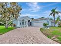 Charming single-story home with well-manicured lawn, stone-paved driveway, and lush tropical landscaping at 5139 50Th W Ave, Bradenton, FL 34210