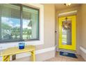 Welcoming entryway featuring a bright yellow door and decorative accents at 529 Sunset N Rd, Rotonda West, FL 33947
