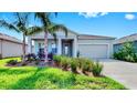 Well-maintained single-Gathering home with a two-car garage, front yard greenery, and colorful shutters at 6120 115Th E Ave, Parrish, FL 34219