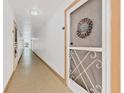 Inviting hallway leading to a unit entrance at 618 Bird Bay S Dr # 113, Venice, FL 34285