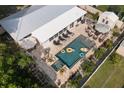 An aerial shot showcases this home's backyard oasis featuring a pool, sun loungers and tropical landscaping at 6180 42Nd N Ave, St Petersburg, FL 33709