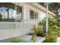 A charming front porch offers a swing, fresh paint, and an invitation to relax in this home at 6180 42Nd N Ave, St Petersburg, FL 33709