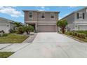 Charming two-story home with a well-maintained lawn and an inviting two car driveway at 6256 Springmont Loop, Palmetto, FL 34221