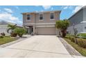 Charming two-story home with a well-maintained lawn and an inviting two car driveway at 6256 Springmont Loop, Palmetto, FL 34221