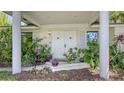 Welcoming front entrance featuring double doors, columns, and a well-maintained, landscaped garden at 626 46Th St, Sarasota, FL 34234