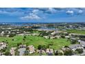 Stunning aerial view of the community surrounded by lush greenery, serene lakes, and the ocean at 718 White Pine Tree Rd # 80, Venice, FL 34285