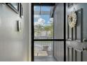 Front door leading to wood balcony with flower pot and view of the community at 7214 Cloister Dr # 7214, Sarasota, FL 34231