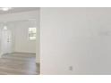 Bright and airy living room with modern gray wood-look floors, fresh white walls, and ample natural light at 7308 17Th W Ave, Bradenton, FL 34209