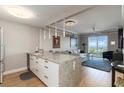 Modern living space with granite counters, pendant lighting, and water views at 750 N Tamiami Trl # 1005, Sarasota, FL 34236