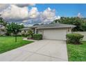 Well-maintained single-story home boasting an attached two-car garage and mature landscaping at 813 Oak Pond Dr, Osprey, FL 34229