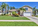 Charming single-Gathering home with lush landscaping, mature palm trees and two car garage at 815 Greenview Dr, Apollo Beach, FL 33572
