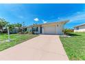 Single-story home featuring a driveway, front yard, and a freshly landscaped garden at 8321 43Rd Ave W, Bradenton, FL 34209
