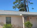 Close-up of a single-story home's facade with a window and a number on the door at 8409 Trionfo Ave, North Port, FL 34287