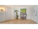 Inviting hallway with elegant decor and wood floors that lead to different parts of the home at 1 Benjamin Franklin Dr # 93, Sarasota, FL 34236