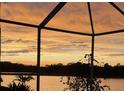 Enjoy serene lake views from the screened lanai, perfect for relaxation and enjoying the tranquil sunset at 10571 Old Grove Cir, Bradenton, FL 34212