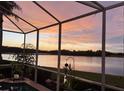 Relax by the pool on the screened patio with breathtaking sunset and lake views, creating a serene retreat at 10571 Old Grove Cir, Bradenton, FL 34212