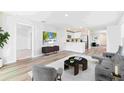 Open-concept living area featuring contemporary furnishings and hardwood flooring at 12055 Lansing Gln, Parrish, FL 34219