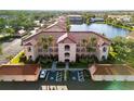 Exterior of condo building showcasing architecture, landscaping, and convenient parking at 150 L Pavia Blvd # 13, Venice, FL 34292