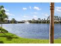 Picturesque lake view with fountain surrounded by lush greenery and blue skies at 150 L Pavia Blvd # 13, Venice, FL 34292