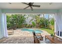 Backyard oasis with lush landscaping and a private pool at 1738 Siesta Dr, Sarasota, FL 34239