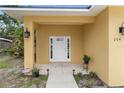 A welcoming covered entrance with a modern white door and decorative wall sconces at 204 21St Ne St, Bradenton, FL 34208