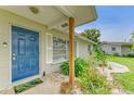 Inviting front entrance with a vibrant blue door and decorative landscaping at 237 Saxon Cir, Venice, FL 34293