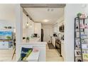 Well-lit, all-white kitchen featuring stainless steel appliances and modern finishes at 237 Saxon Cir, Venice, FL 34293