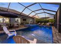The screened-in pool area has a jacuzzi, an outdoor kitchen, and lots of room to relax at 2586 Wild Cherry Path, Sarasota, FL 34240
