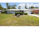 Charming single-story home featuring a well-manicured lawn and a white tiled roof at 307 Rubens Dr, Nokomis, FL 34275