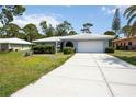 Charming single-story home featuring a well-manicured lawn and a white tiled roof at 307 Rubens Dr, Nokomis, FL 34275