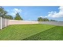 Spacious and well-kept backyard featuring a lush lawn and privacy fence, great for relaxation and entertainment at 3813 Willow Branch Pl, Palmetto, FL 34221