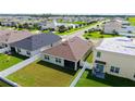 Aerial view of a well-maintained backyard with green lawn and white fence, perfect for outdoor activities at 3813 Willow Branch Pl, Palmetto, FL 34221