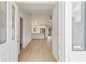 Bright and airy foyer featuring stylish light-colored floors that flow into the kitchen and main living areas at 4250 Winfall Ave, North Port, FL 34286
