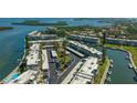 Aerial view of condo complex with waterfront access, boat slips, parking, and lush landscaping at 4420 Exeter Dr # 303, Longboat Key, FL 34228