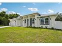 A beautifully landscaped front yard with a modern single-story home and fresh green grass at 4855 Dragon St, North Port, FL 34288