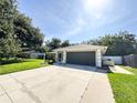 Long driveway leading to a single-story home with an attached garage, surrounded by trees at 4913 32Nd E St, Bradenton, FL 34203