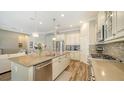 Open-concept kitchen featuring a large island, stainless appliances, and ample cabinetry at 5234 Napoli Run, Bradenton, FL 34211