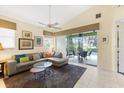 Cozy living room with tile flooring, comfortable seating, and sliding glass doors opening to the outdoor patio at 6155 Aviary Ct, Bradenton, FL 34203